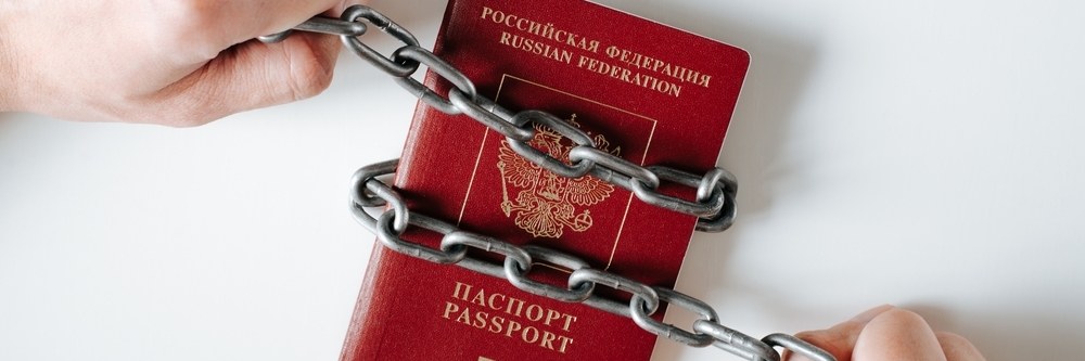 Close-up of canceled international biometric passport of citizen of Russian Federation chained